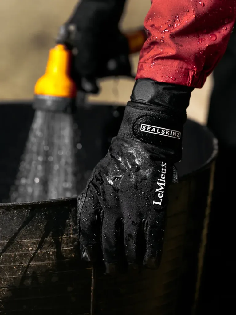 LeMieux x Sealskinz waterproof glove Rider wearing the black LeMieux Sealskinz waterproof glove beside a water tub