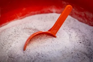 A scoop of supplement in a feed bucket