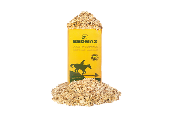 Bag of Bedmax large-flake pine horse bedding with loose shavings